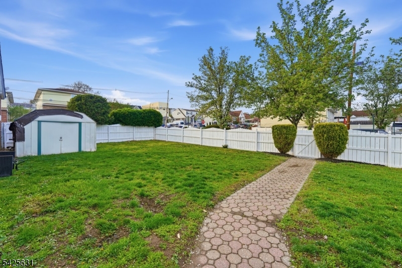 60 Westervelt Place Lodi, NJ 07644 - Photo 40 of 48 a view of a backyard with large trees