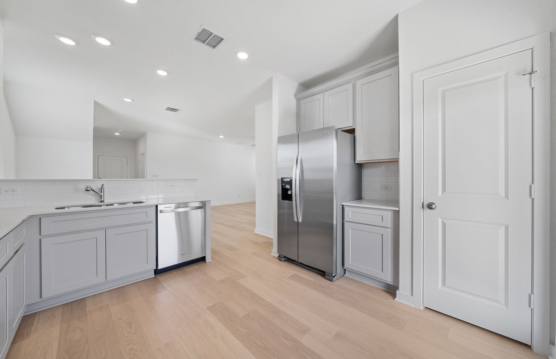 608 Rubber Tree Way Buda, TX 78610 - Photo 3 of 29 a large kitchen with a sink and refrigerator