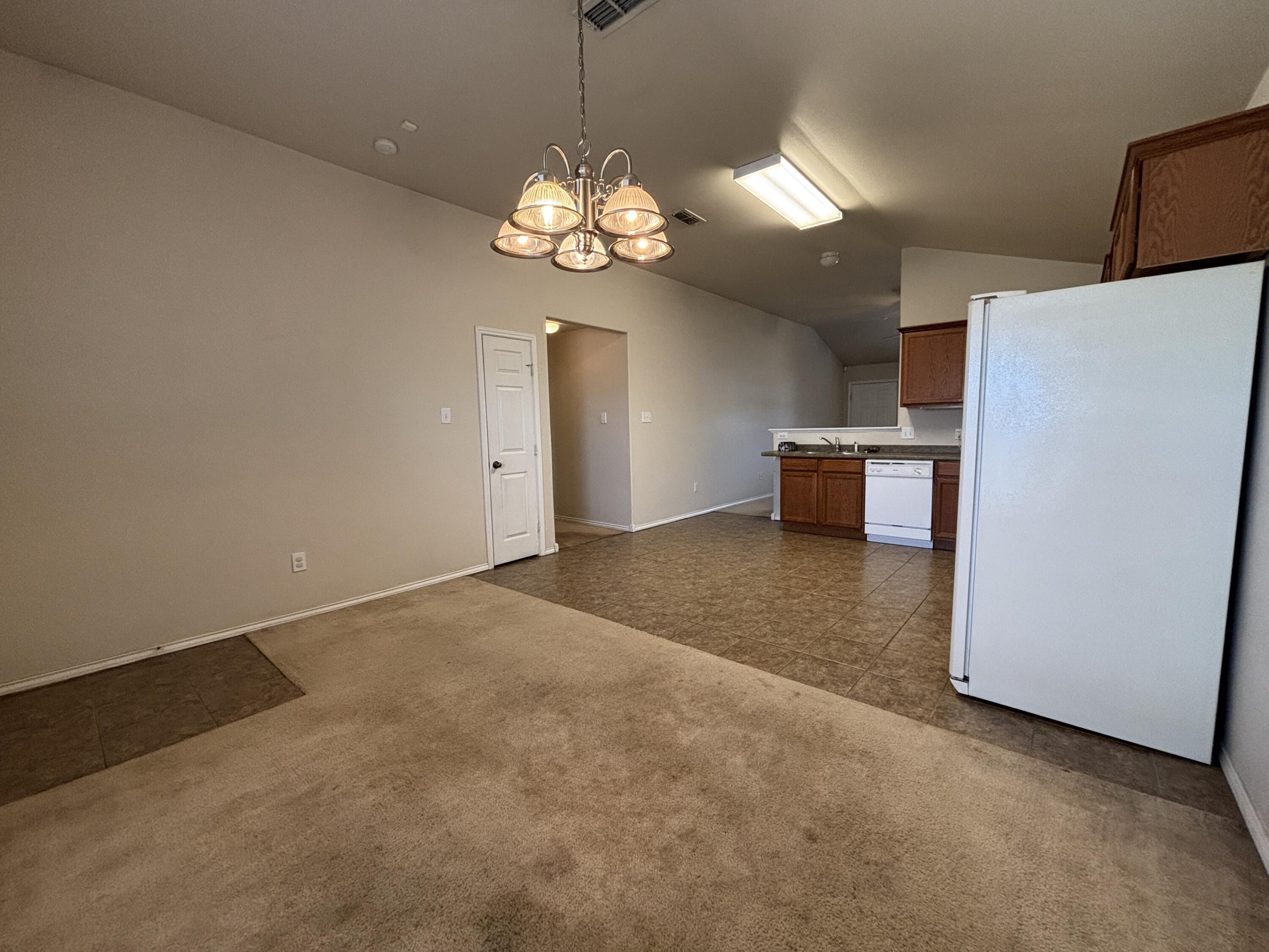 6515 92nd Street Lubbock, TX 79424 - Photo 4 of 9 a view of a kitchen with a sink and a refrigerator