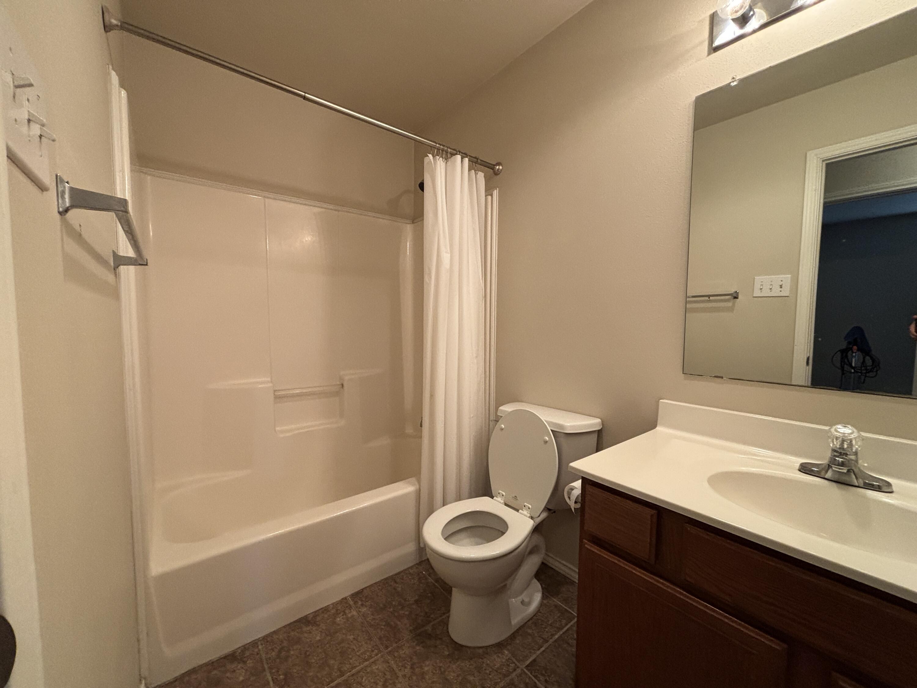 6515 92nd Street Lubbock, TX 79424 - Photo 8 of 9 a bathroom with a sink toilet tub and shower