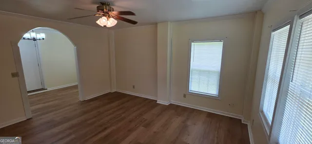 wooden floor in an empty room with a window