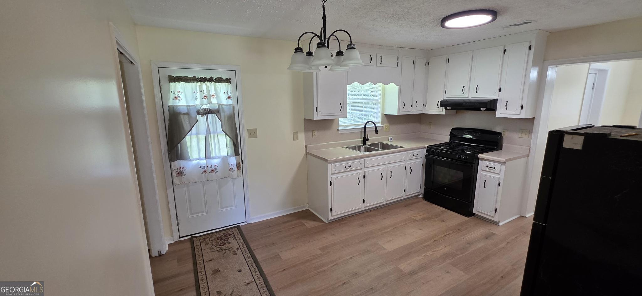 657 Tom McKinley Road Thomaston, GA 30286 - Photo 19 of 32 a kitchen with stainless steel appliances a refrigerator sink and cabinets