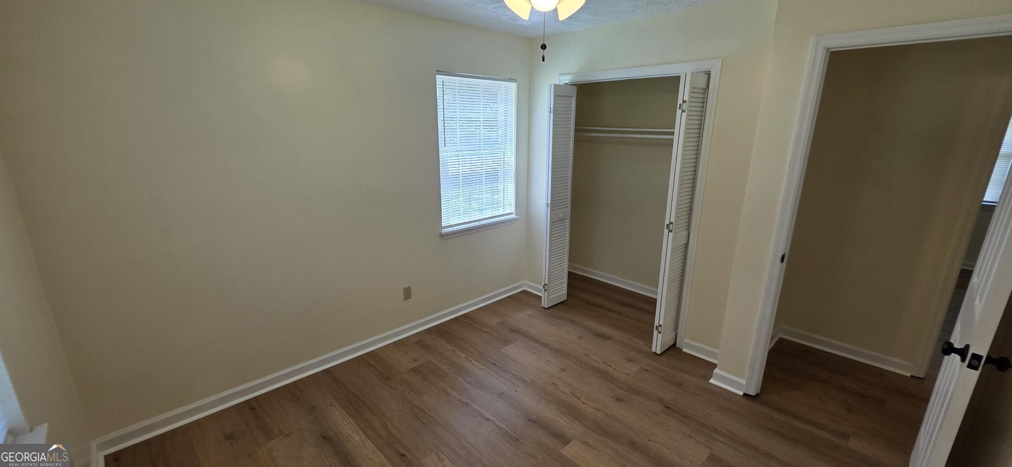 657 Tom McKinley Road Thomaston, GA 30286 - Photo 25 of 32 an empty room with wooden floor and a window