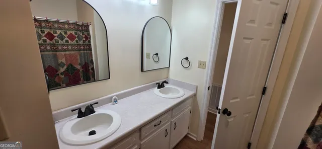 a bathroom with a sink and mirror with toilet