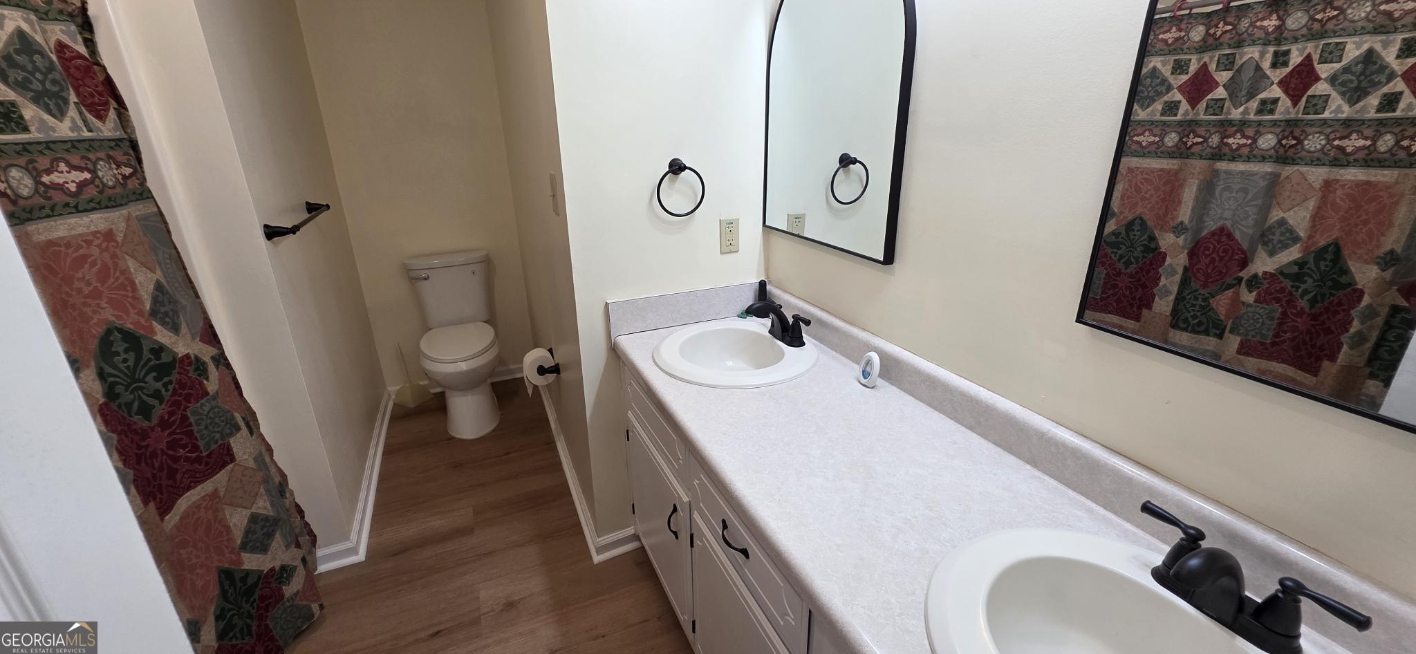 657 Tom McKinley Road Thomaston, GA 30286 - Photo 32 of 32 a bathroom with a sink and mirror with toilet