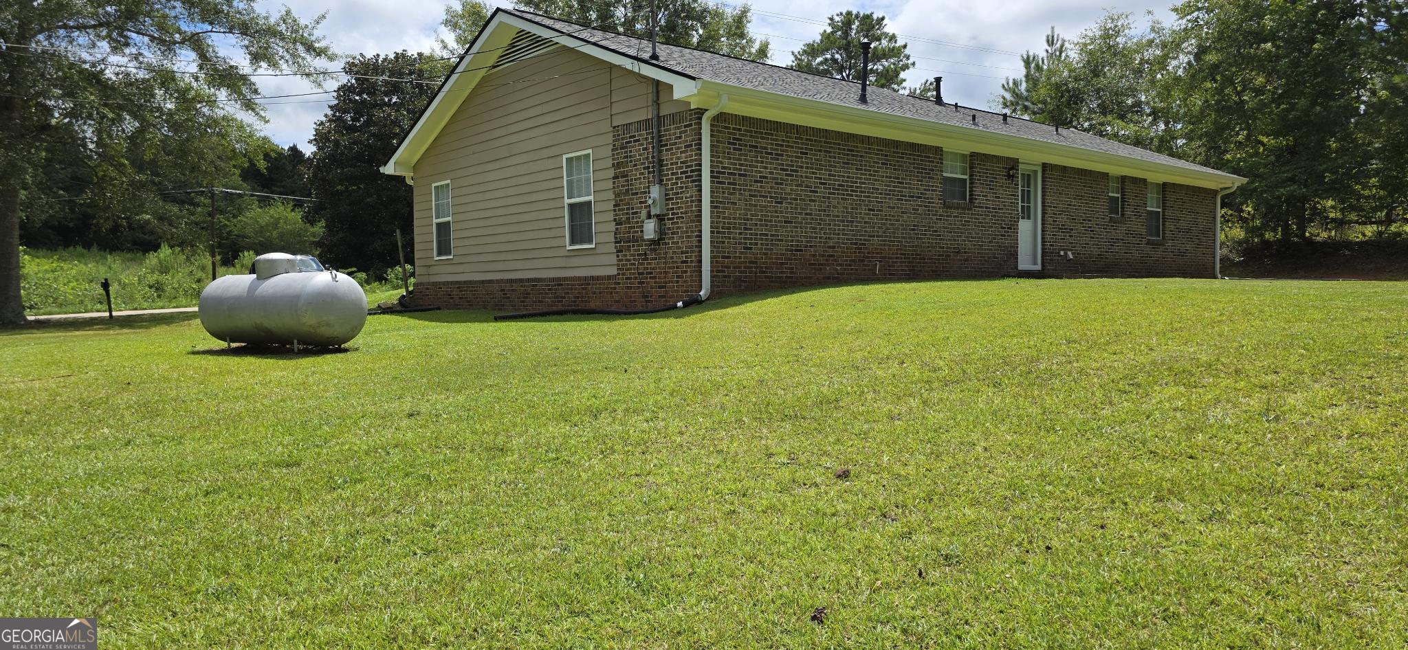657 Tom McKinley Road Thomaston, GA 30286 - Photo 8 of 32 a view of a backyard of the house