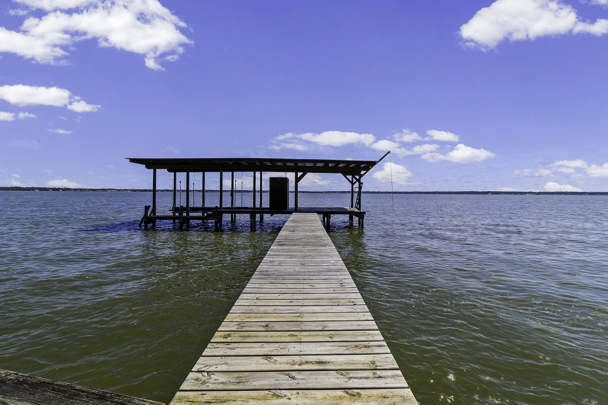 151 Key Largo Loop Point Blank, TX 77364 - Photo 36 of 49 Private covered boat dock extending into open water, offering direct lake access and breathtaking panoramic views.