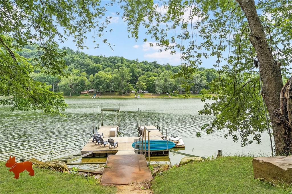 1150 River Road Freeport, PA 16229 - Photo 5 of 16 a view of a lake with lawn chairs and couches