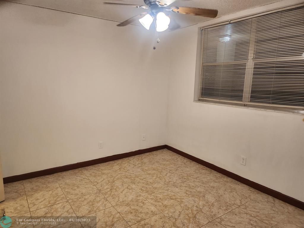 5830 Northwest 64th Avenue, Unit 209 Fort Lauderdale, FL 33319 - Photo 1 of 9 a view of an empty room with a window