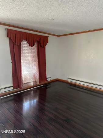 a view of a room with wooden floor