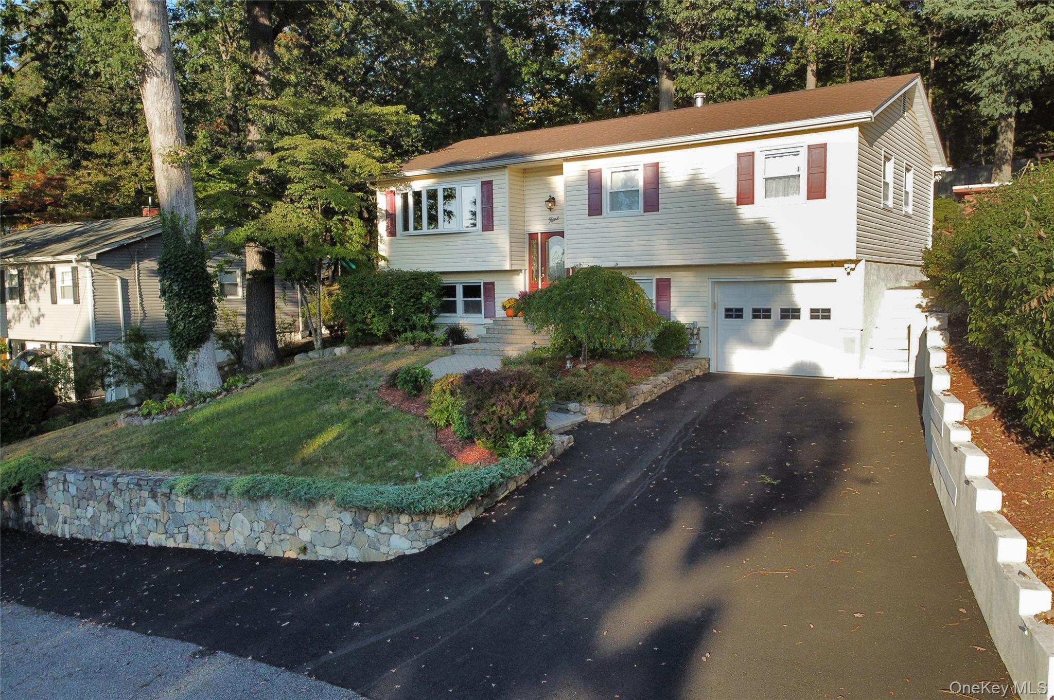 9 Prospect Place Suffern, NY 10901 - Photo 1 of 13 a front view of a house with a yard and garage