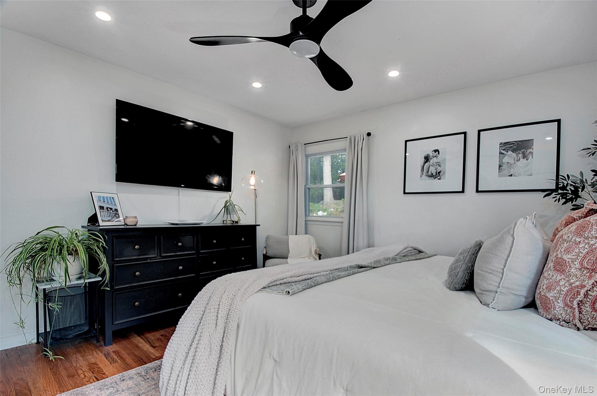 9 Prospect Place Suffern, NY 10901 - Photo 5 of 13 a bedroom with a bed and a flat screen tv