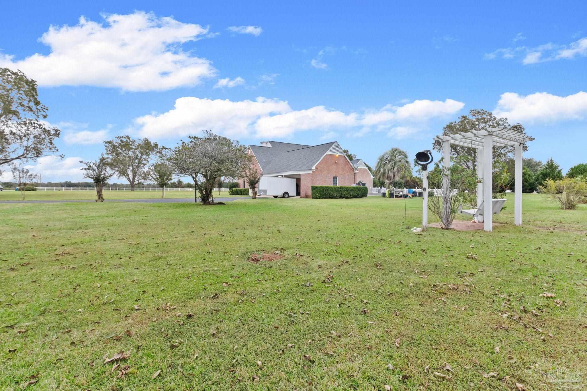 10734 Highway 31 Atmore, AL 36502 - Photo 53 of 65 a view of a green field with an trees in the background
