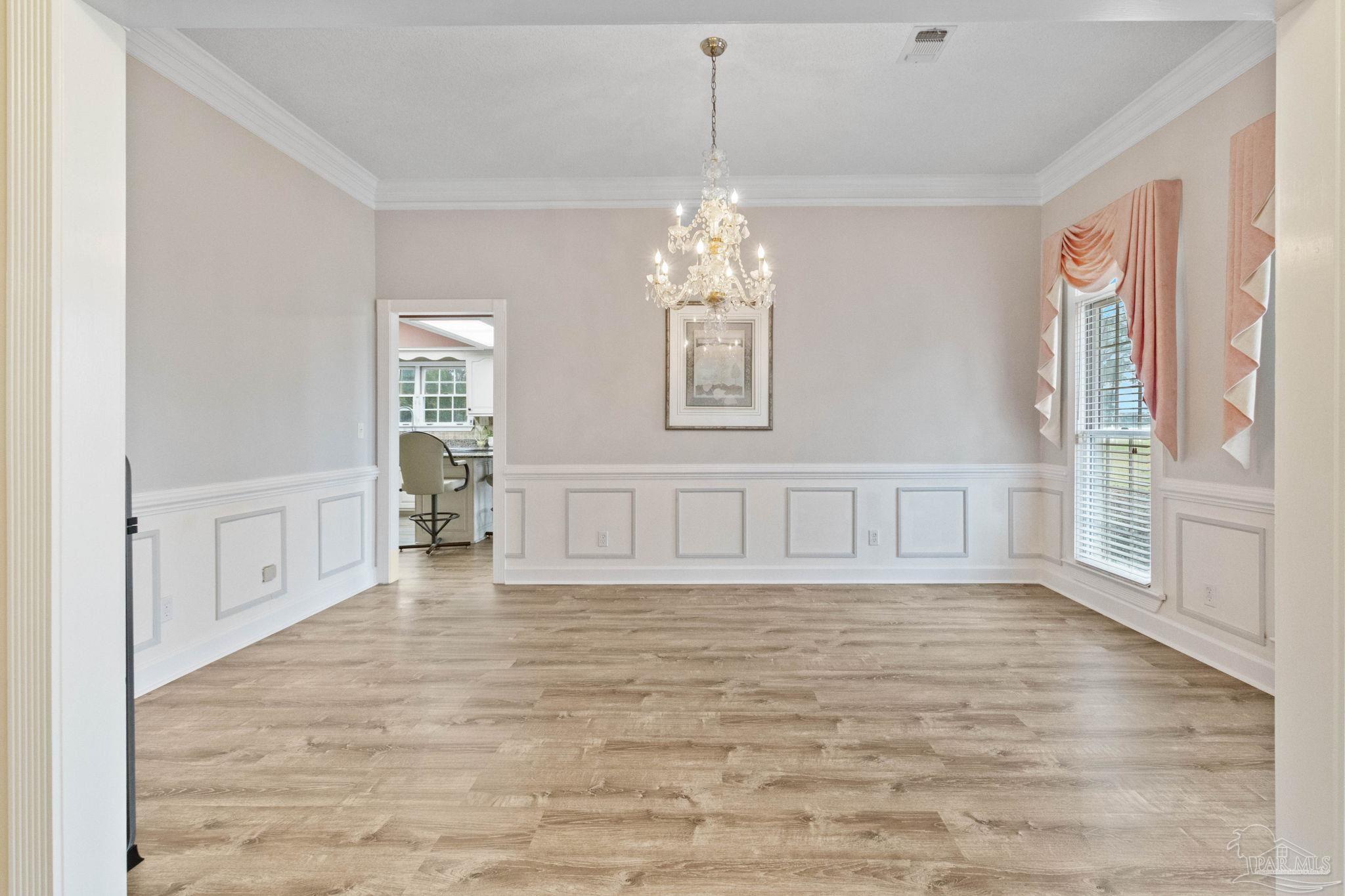 10734 Highway 31 Atmore, AL 36502 - Photo 6 of 65 a view of an empty room with wooden floor and a window