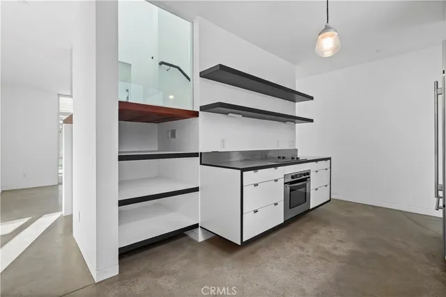a kitchen with white cabinets and appliances