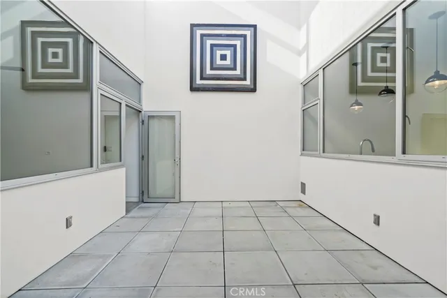 a view of a hallway with closet and bathroom