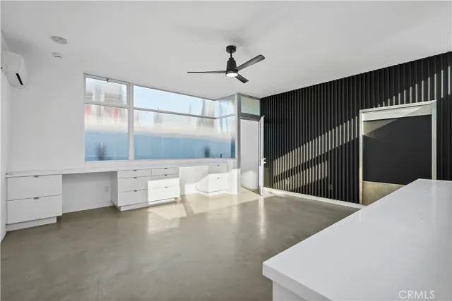 a view of a white house with a swimming pool and a lawn chairs