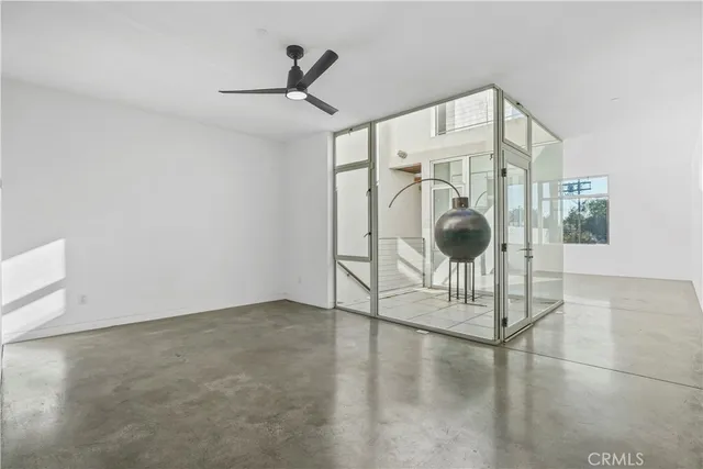 a view of a room with wooden floor and windows