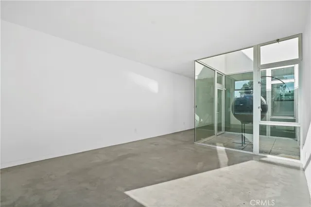an empty room with sliding glass door