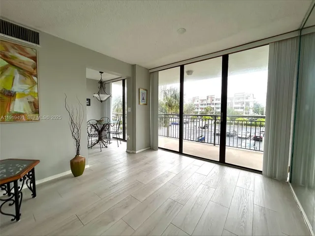 a view of empty room with wooden floor and windows