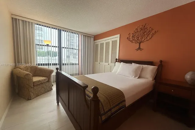 a bedroom with a bed and a couch