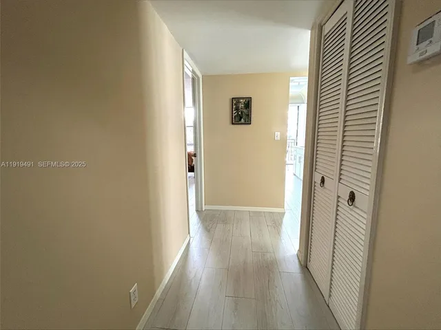a view of a hallway with wooden floor