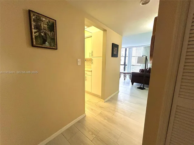 a bedroom with a bed and a flat tv screen on dresser