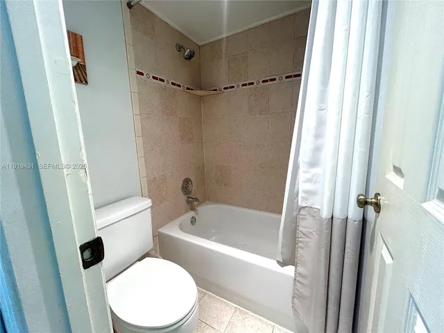a bathroom with a shower sink and mirror