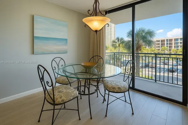 a view of a dining room with furniture wooden floor and chandelier