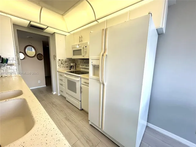 a kitchen with stainless steel appliances a refrigerator a stove and cabinets