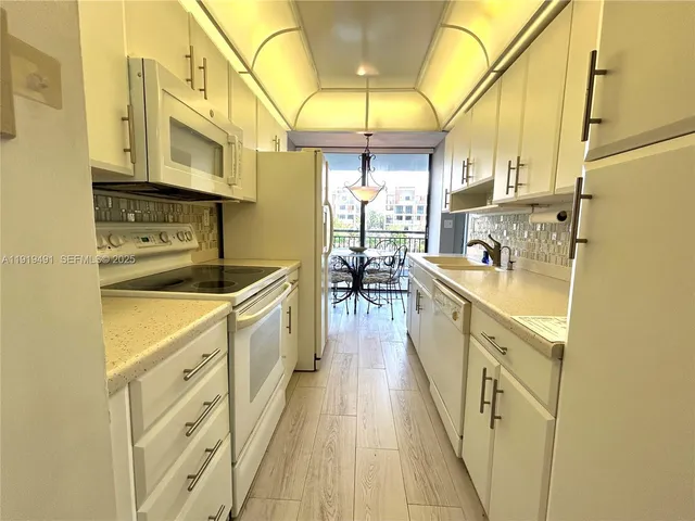 a kitchen with cabinets a sink and appliances