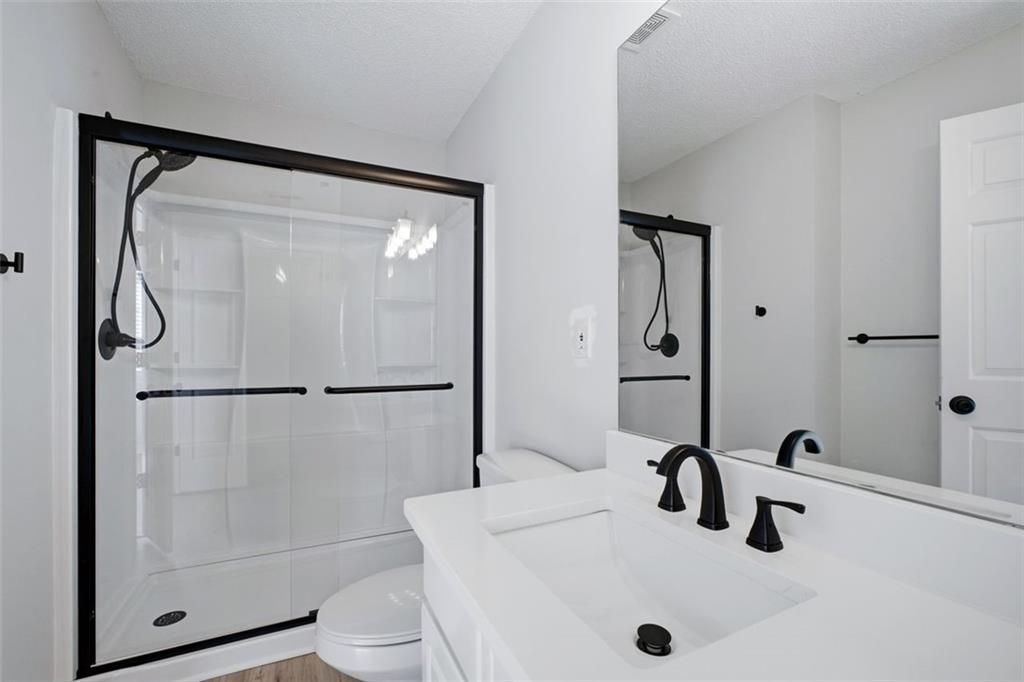 5764 Reps Trace Norcross, GA 30071 - Photo 24 of 32 a bathroom with a sink a toilet and a mirror