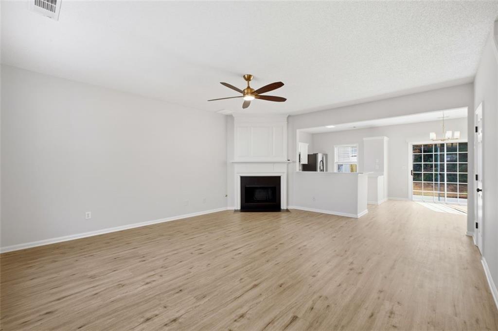 5764 Reps Trace Norcross, GA 30071 - Photo 4 of 32 a view of a livingroom with a fireplace a ceiling fan and wooden floor