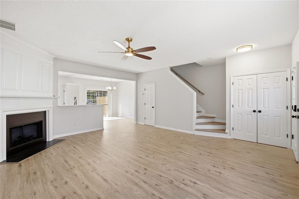 5764 Reps Trace Norcross, GA 30071 - Photo 6 of 32 a view of empty room with wooden floor and fireplace