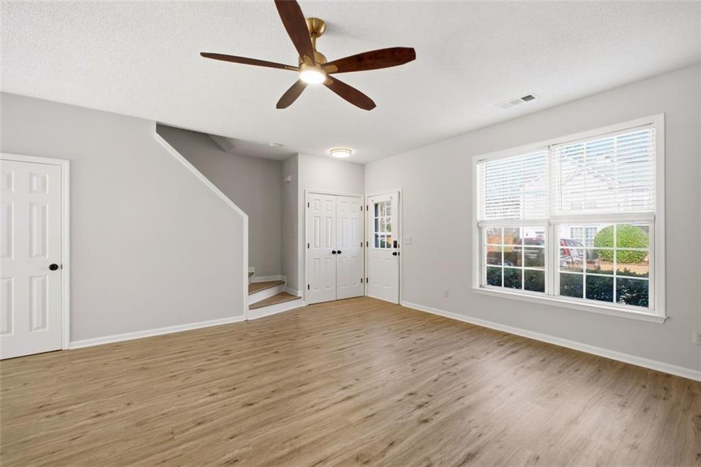 5764 Reps Trace Norcross, GA 30071 - Photo 7 of 32 a view of an empty room with wooden floor and a window