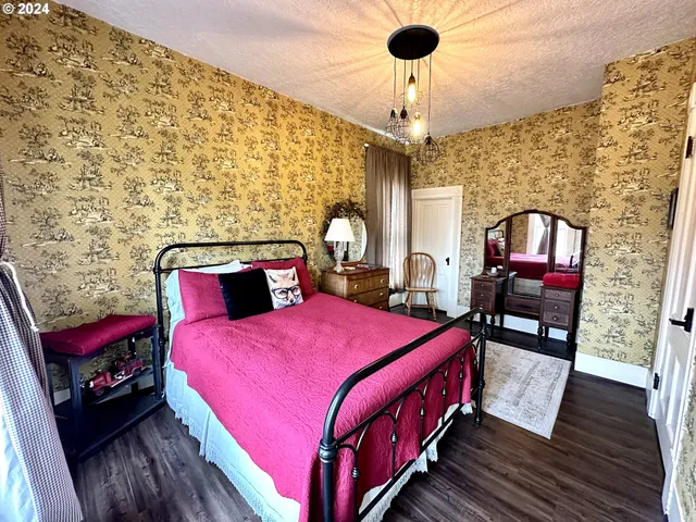 a bed room with a bed and a chandelier