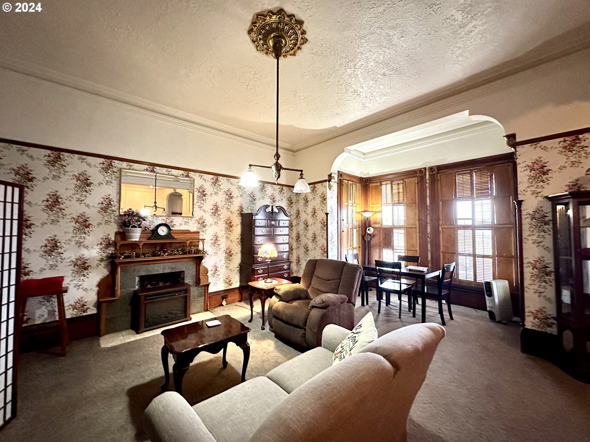 1790 Washington Avenue Baker City, OR 97814 - Photo 10 of 42 a living room with furniture a fireplace and flat screen tv