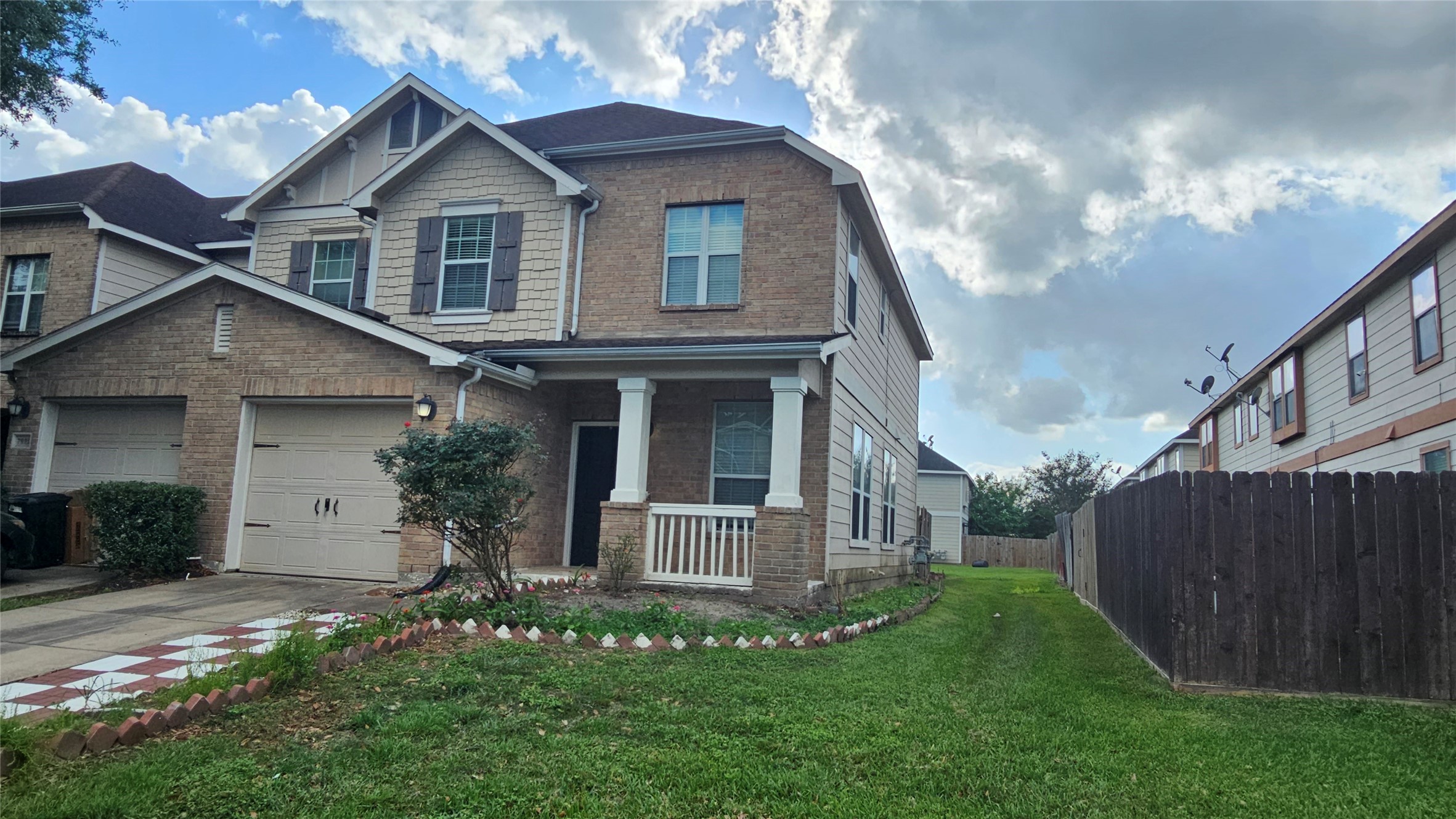 7918 Barnes Ridge Lane Houston, TX 77072 - Photo 1 of 34 This is a beautiful two-story brick and siding home. It features a neatly maintained lawn and is situated between similarly styled houses.
