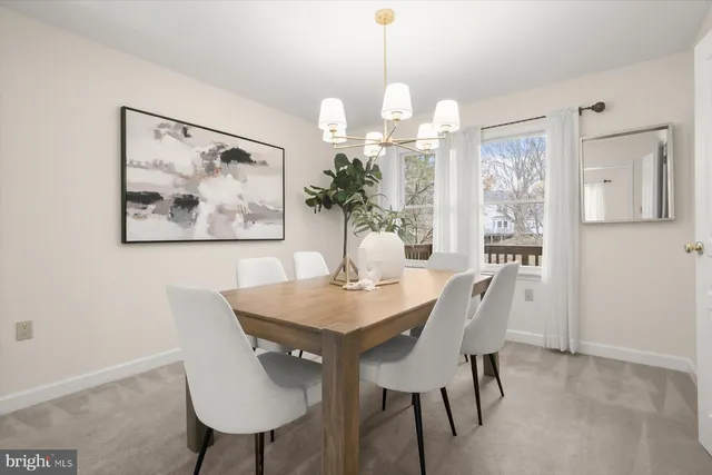 a view of a dining room with furniture wooden floor and a chandelier