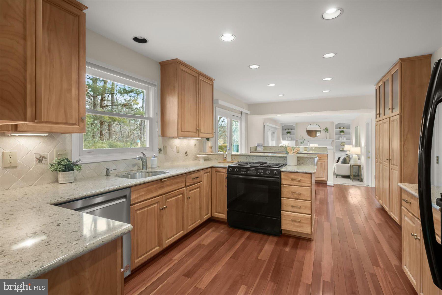 1727 Glastonberry Road Potomac, MD 20854 - Photo 13 of 45 a large kitchen with stainless steel appliances granite countertop a lot of counter space and wooden floors