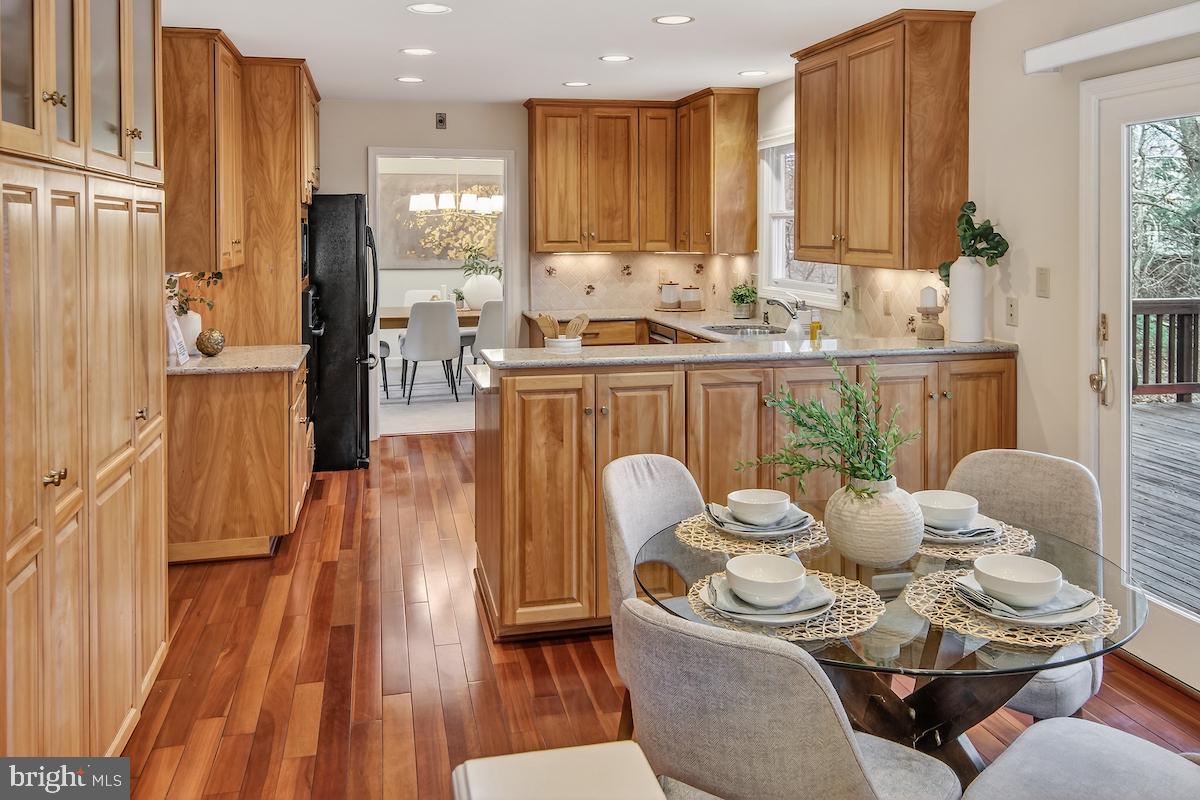 1727 Glastonberry Road Potomac, MD 20854 - Photo 16 of 45 a dining room with furniture and wooden floor