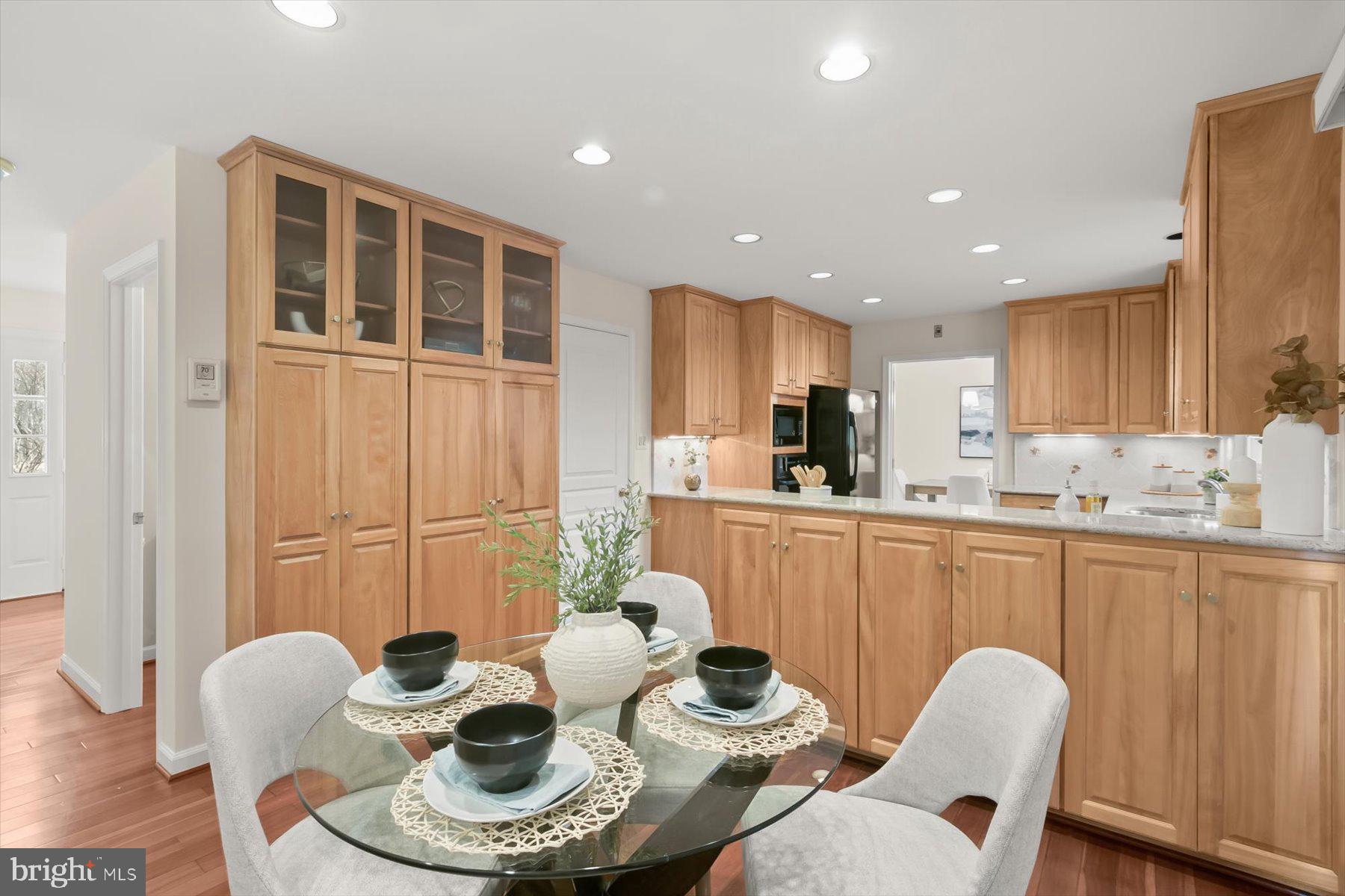 1727 Glastonberry Road Potomac, MD 20854 - Photo 20 of 45 a kitchen with granite countertop kitchen island stainless steel appliances a dining table and chairs