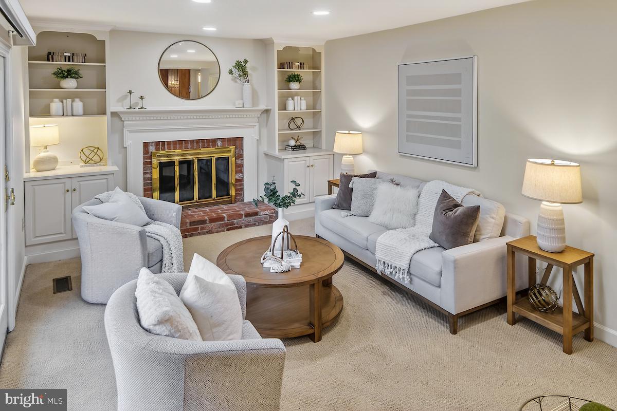 1727 Glastonberry Road Potomac, MD 20854 - Photo 23 of 45 a living room with furniture and a fireplace