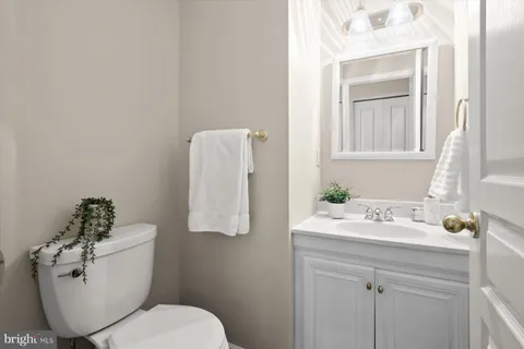 a spacious bedroom with a bed and a chandelier