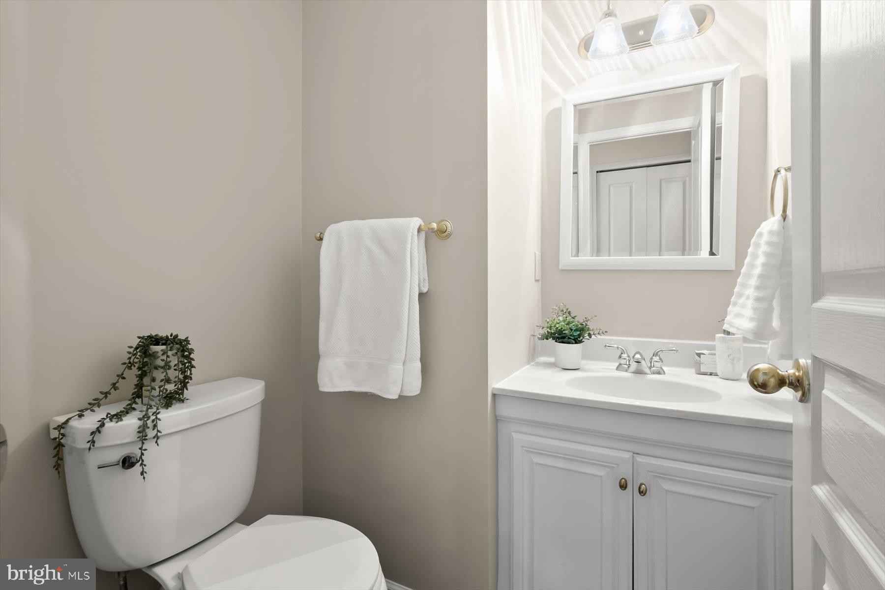 1727 Glastonberry Road Potomac, MD 20854 - Photo 24 of 45 a bathroom with a sink mirror and toilet