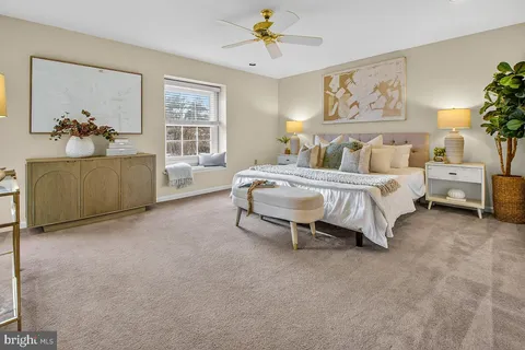 a view of a hallway with a livingroom and a bathroom with sink