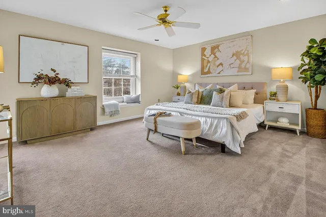 a view of a hallway with a livingroom and a bathroom with sink