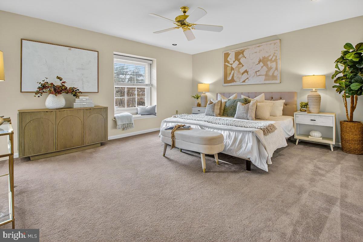 1727 Glastonberry Road Potomac, MD 20854 - Photo 26 of 45 a spacious bedroom with a bed and a chandelier