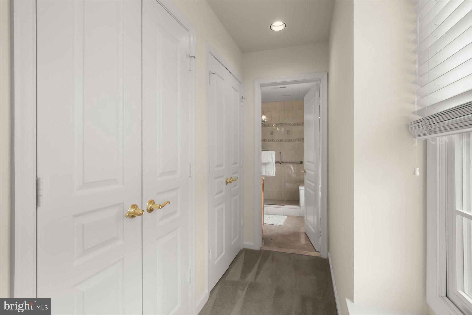 1727 Glastonberry Road Potomac, MD 20854 - Photo 28 of 45 a view of a hallway with a livingroom and a bathroom with sink