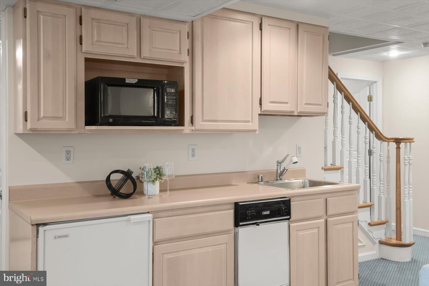 1727 Glastonberry Road Potomac, MD 20854 - Photo 40 of 45 a kitchen with white cabinets and a sink